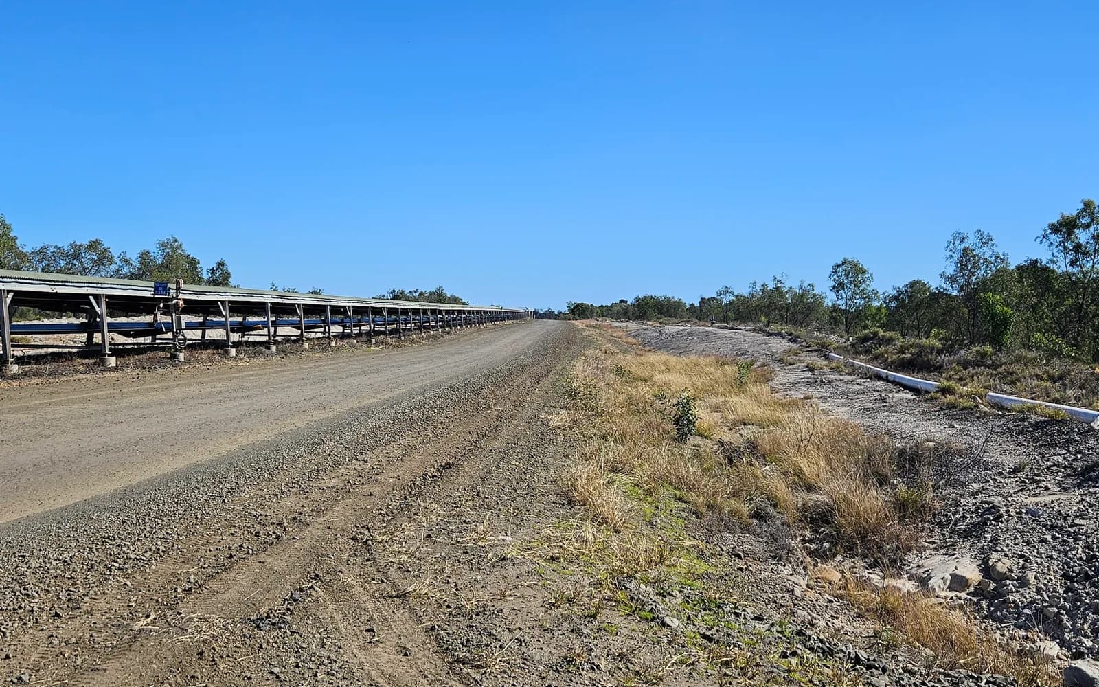 Overland conveyor and service road beside the Blair Athol rehabilitation area at Clermont Coal Mine, part of the lease covered by the catchment plans