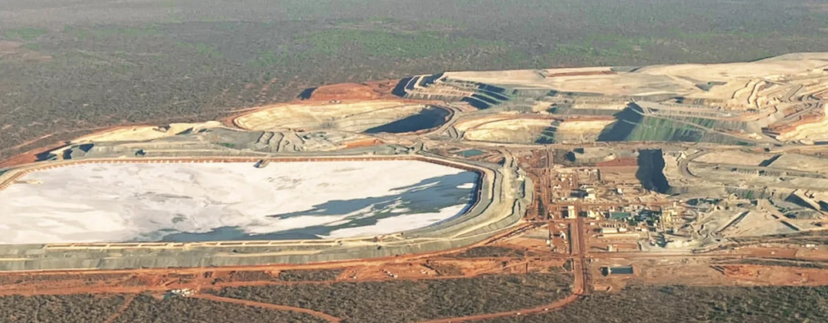 Aerial view of the Tropicana Gold Mine tailings storage facility, with the open pits and plant beyond in the Great Victoria Desert